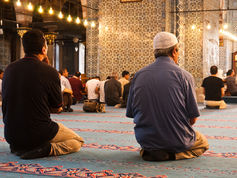 men praying together in mosque