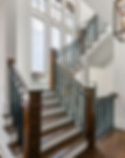 Stair case with tall windows