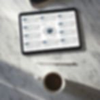 iPad Pro with Apple Pencil on the marble desk beside the notepad and a cup of coffee_brooo