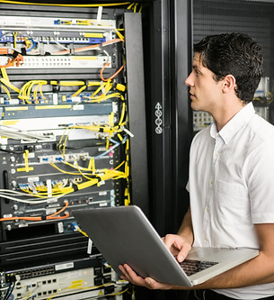 Technician using laptop to analyse serve