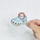 Thumbnail: Acrylic resin pin featuring a blue Croc shoe with a Chucky-inspired character peeking out from inside.