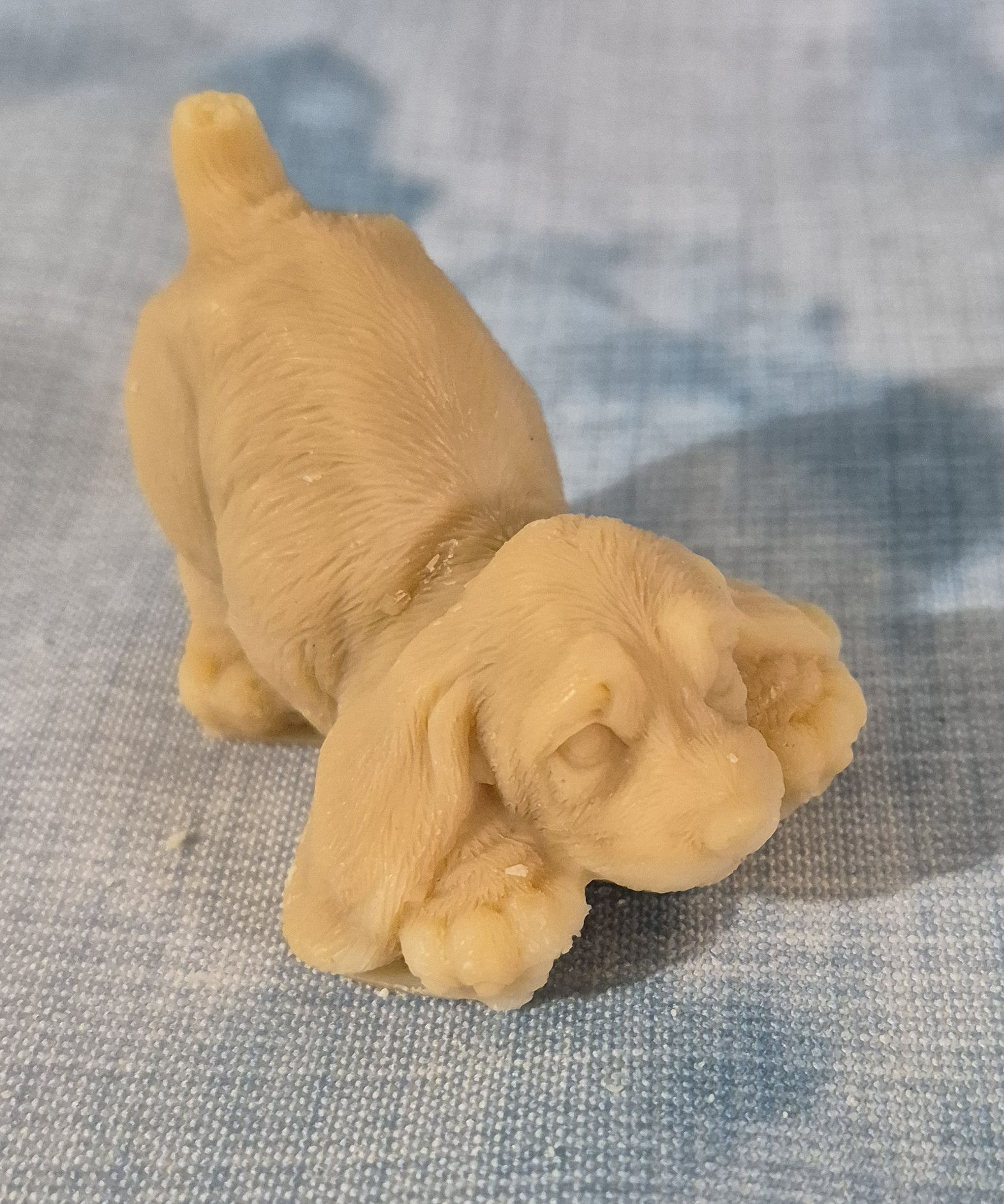 A bowing puppy molded soap asking for playtime.