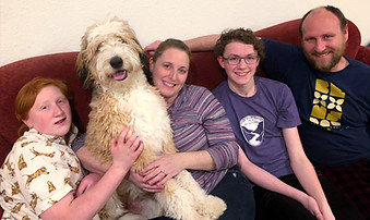 happy family with their bernedoodle