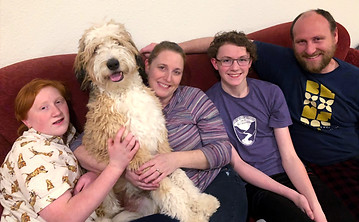 happy family with their bernedoodle