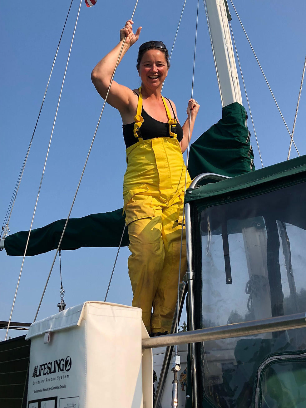 Lucy Finch in her sailing rain pants on a sailboat
