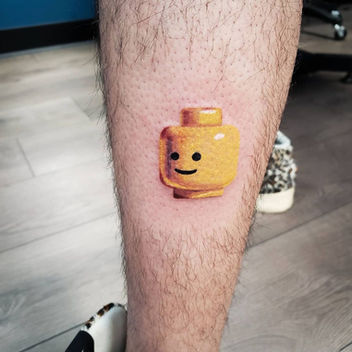 Playful and detailed color realism LEGO tattoo by artist Sole. This eye-catching tattoo features a realistic rendition of a LEGO brick, showcasing intricate details and vibrant colors. A whimsical nod to childhood nostalgia, the tattoo captures the essence of the iconic toy in a unique and creative way.