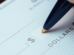 Image of person signing a check