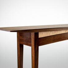 The crisp clean lines of a traditional Shaker hall table have been updated with graceful curves and figured maple. Additionally the contrast between the curly maple and black walnut is highlighted by a narrow gap that separates the two woods. While honoring the aesthetic of the Shaker movement through the use of hand cut mortise and tenon joinery this table would be at home in any modern residence. (American Black Walnut and Figured Maple) Custom handmade furniture. Work done by Arieus Woodworks hand crafted by Rob Shefner.