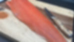 A sockeye salmon fillet on a cutting board