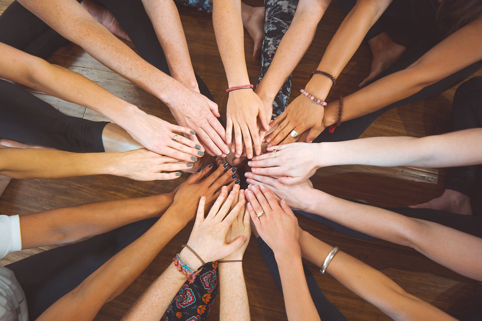 Diverse groupd of women's hands coming together for a workshop