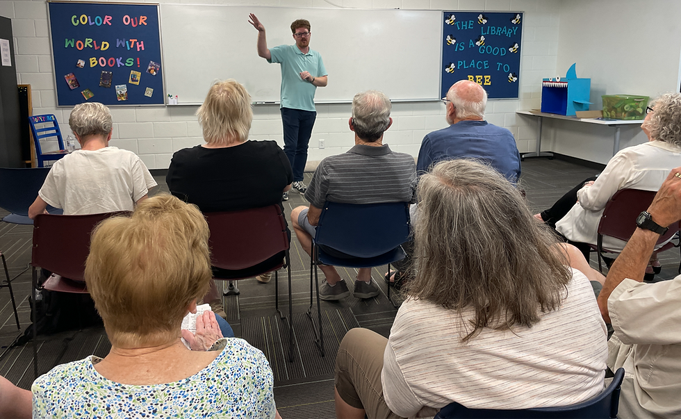 a man addresses a room of adults