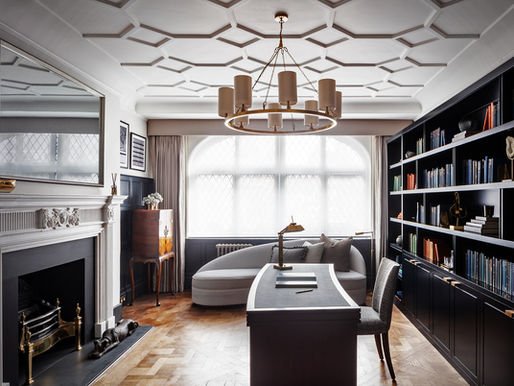 Elegant London interior design with bespoke joinery, large windows, and fitted shelving in a home office with historic detailing.