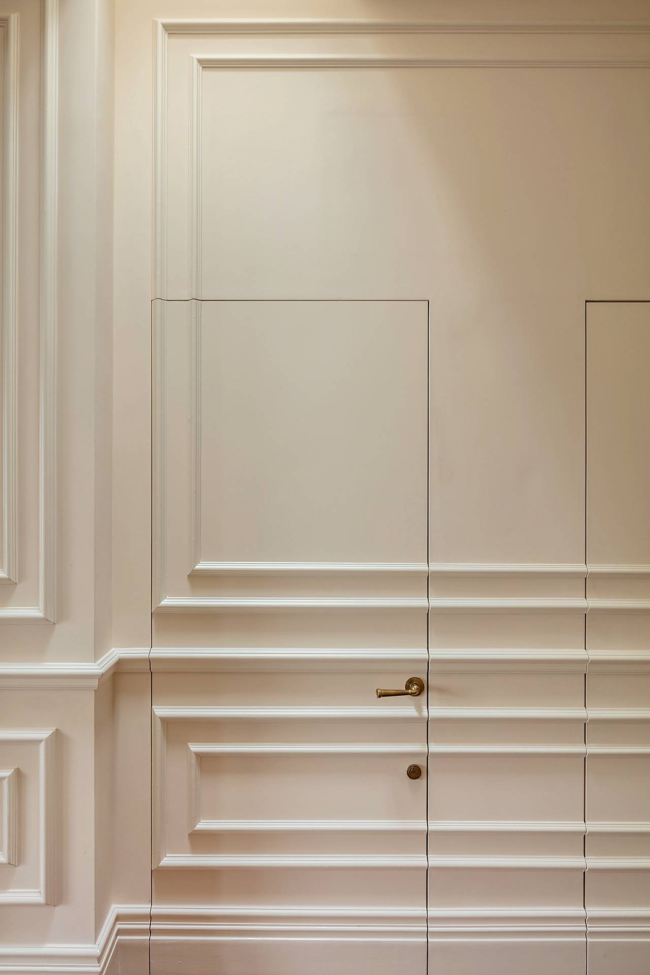 Hidden door with Cochrane Bespoke joinery detail, flush-fitted into traditional panelling in a luxury London interior.