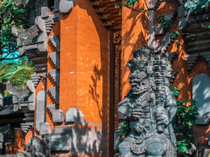A traditional split Balinese temple gate framing a path under a clear sky