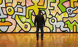 man wearing black jacket and pants facing multicolored graffiti_edited_edited_edited_edite