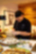 Chef WIlliam is smiling while preparing the dishes