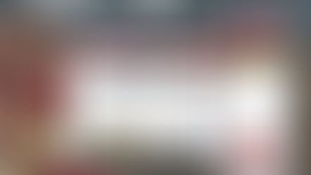 Three people smiling at a smartphone, with a laptop and phone displaying the Driftscape digital tourism app with Niagara Falls website content. Background features geometric wall.