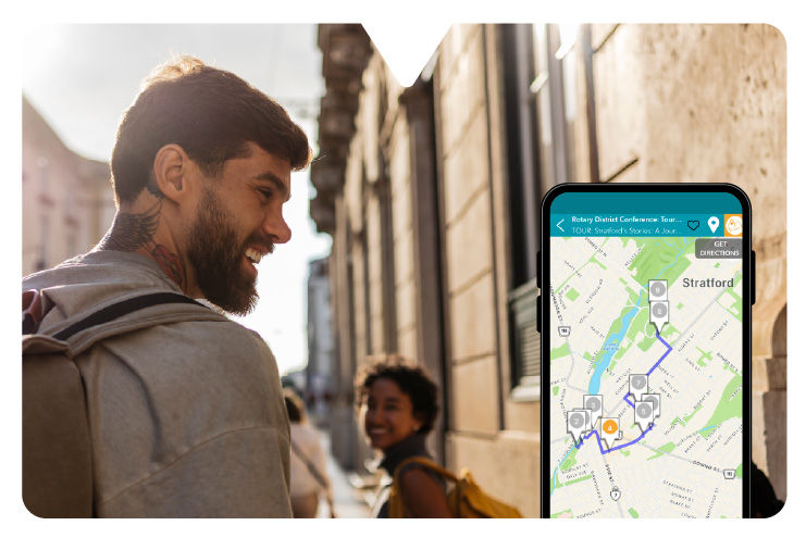 A smartphone shows the Driftscape app displaying a map with a self-guided city tour.