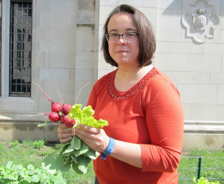 Katie Thomas holds radishes in the Wesley UMC garden.