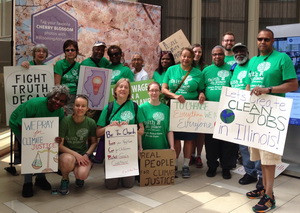 Faithful Citizens show off their signs before the People's Climate March