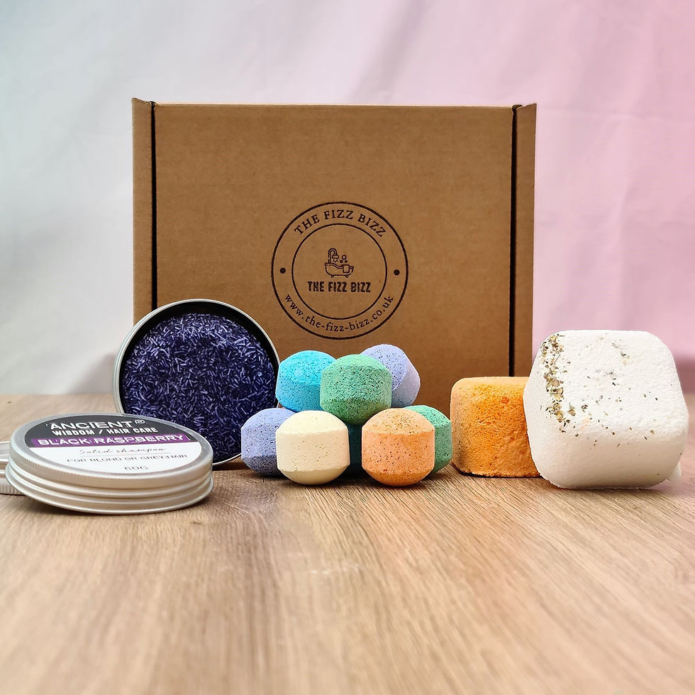 10 mixed mini bath bomb Chill Pills, 2 Shower steamers and a black raspberry solid shampoo bar in front of included gift display box