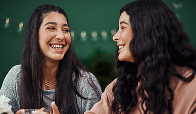 Two young women having meaningful conversation at coffee shop
