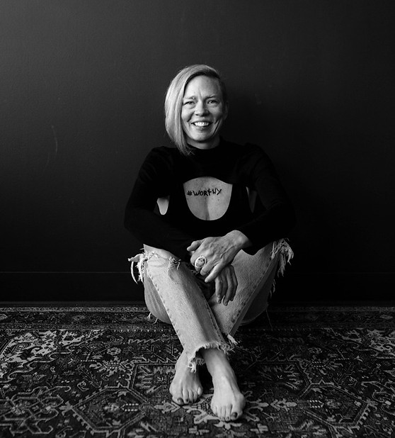 Natalie P, founder of Bloomstruck, sitting on a rug