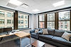 Modern office interior with desk and sofa by large windows. project from Blueprint
