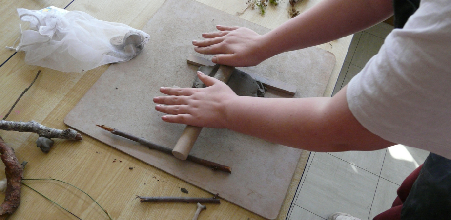 A child working with clay in an art class