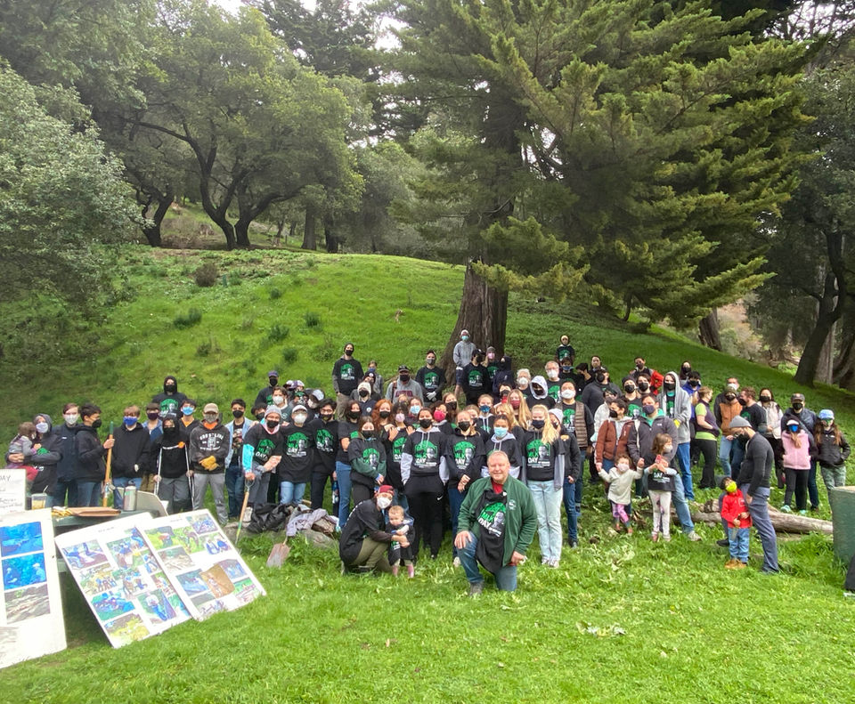 A large crowd of volunteers pose for a photo in Shepherd Canyon.