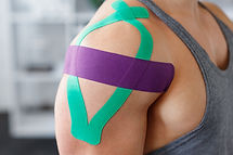 Kinesiology taping. Kinesiology tape on patient shoulder. Injured shoulder treatment of yo