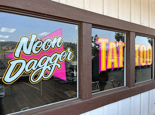Neon Dagger Tattoo Exterior Storefront Hand-Painted Window Signage by Sign Artist Alex Kurakake of Smart Alex Signs - Orange County Hand-Painted Sign Company. Sign Hand-Painted at 5207 1/2 Biloxi Ave. North Hollywood, CA 91601. Los Angeles Premium Hand-Painted Sign Solutions Company. Call: 714-515-6205