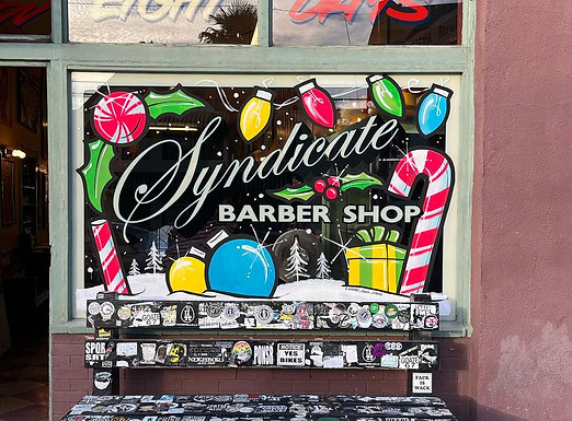 Syndicate Barbershop Exterior Storefront Hand-Painted Christmas Windows by Sign Artist Alex Kurakake of Smart Alex Signs - Orange County Hand-Painted Sign Company. Sign Hand-Painted at 2749 E. Broadway Long Beach, CA 90803. Los Angeles Premium Hand-Painted Sign Solutions Company. Call: 714-515-6205