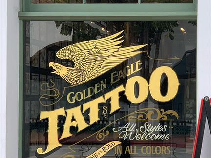 Custom Exterior 23K Gold Leaf Window Storefront Hand-Painted Signs for Client GOLDEN EAGLE TATTOO by Los Angeles Trade Tech Sign Alumni Hand-Painted Sign Artist Alex Kurakake of Smart Alex Hand-Painted Signs in Santa Barbara Orange County Hand-Painted Signs Company Southern California Sign Painting Workshops Call: 714-515-6205