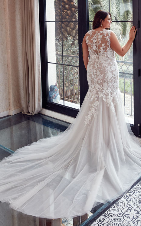 back of woman wearing Eddy K bridal Mermaid wedding gown with beaded ivory lace and sequins over champagne tulle, illusion high neck and back, buttons to end of train.
