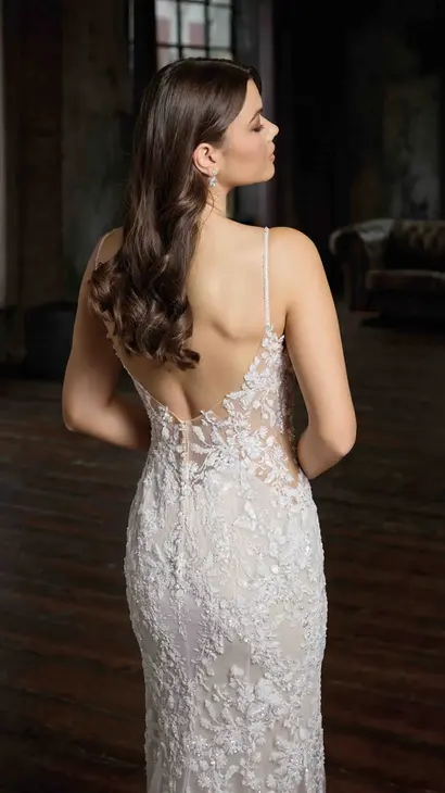 Close-up back of Eddy K fit-n-flare wedding dress with a v-neck neckline and a sleeveless body on a bridal model posing in a studio.