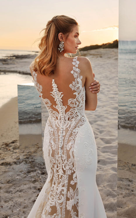 Ivory crepe fit-n-flare wedding dress with lace illusion back in nude at beach with mirrors