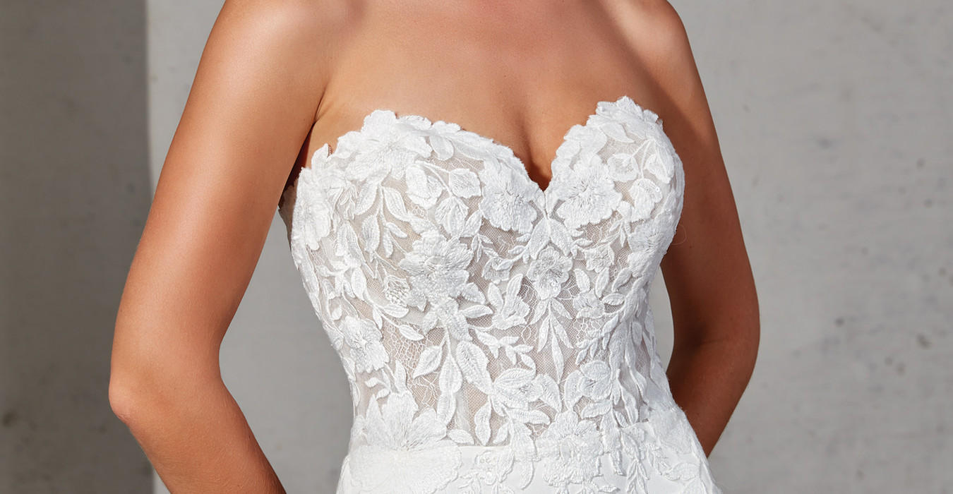 Eddy K Crepe mermaid wedding gown with sweetheart neckline on blonde model with pony tail