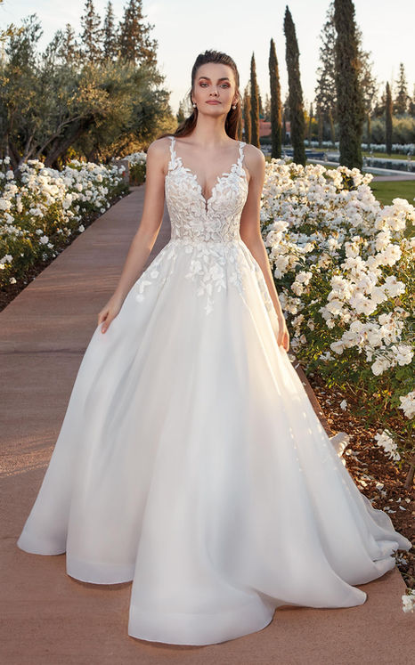 Bride in ivory organza ballgown wedding dress with ivory lace and pockets in garden wedding