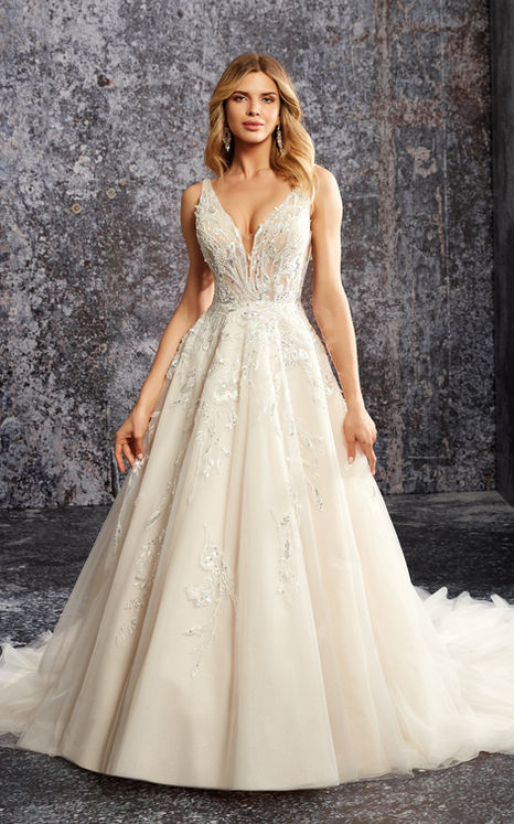 Woman wearing Eddy K ballgown wedding gown with ivory lace and sequins and shimmer tulle in studio