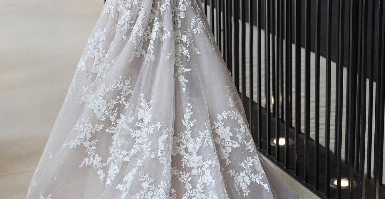 Back of Eddy k a-line with v-neck neckline on fair skinned woman standing in reception hall