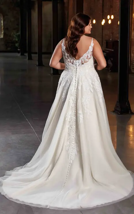 Back of Eddy K a-line lace and tulle wedding dress with spaghetti straps and bridal model in warehouse