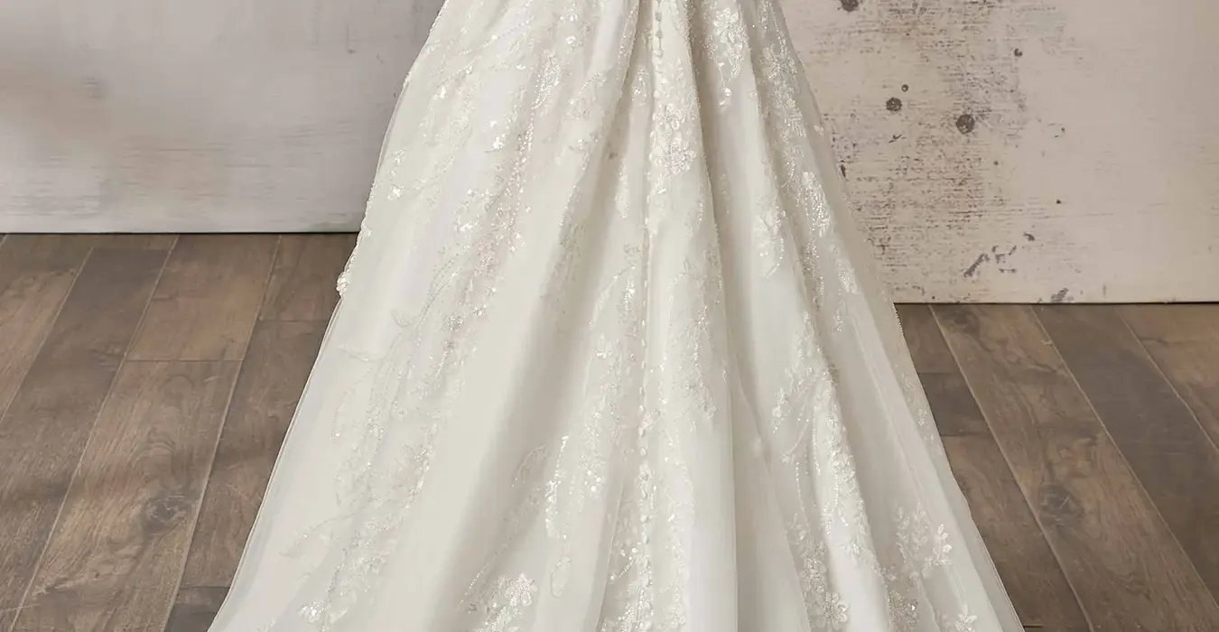 Back of Eddy K tulle a-line wedding dress with a straight neckline and a sleeveless body on a bridal model posing in a photo studio