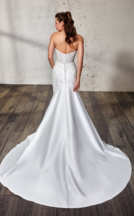 back of woman wearing mermaid sweetheart wedding gown with beaded ivory lace and sequins over ivory tulle with Mikado skirt and buttons to end of train. 