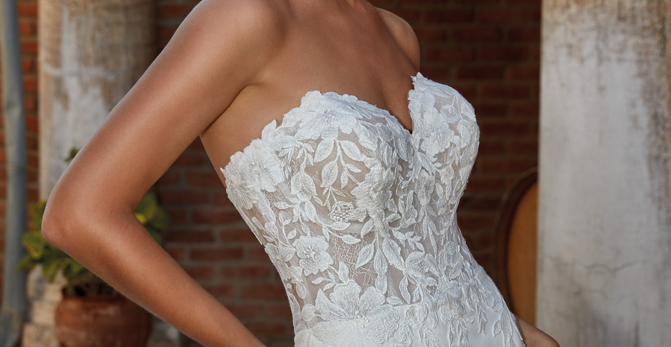 Eddy K Crepe mermaid wedding gown with sweetheart neckline on blonde model with pony tail