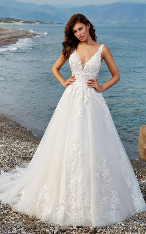 Woman wearing an Eddy K  A-Line wedding gown with lace and tulle, incorporated beaded double belt.