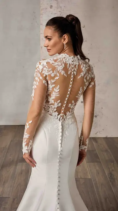 Close up back of Eddy K Mikado mermaid wedding dress with a high neck neckline and a long sleeves body on a bridal model posing in a studio.