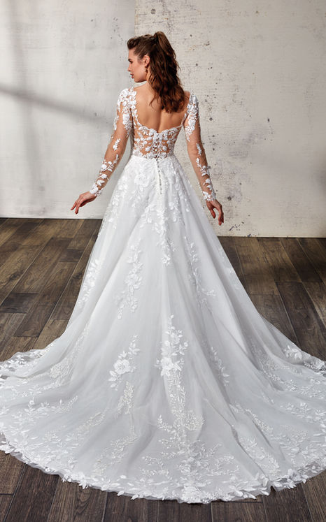woman wearing Eddy K bridal A-Line long sleeve wedding gown with ivory lace and sequins over tulle with open back