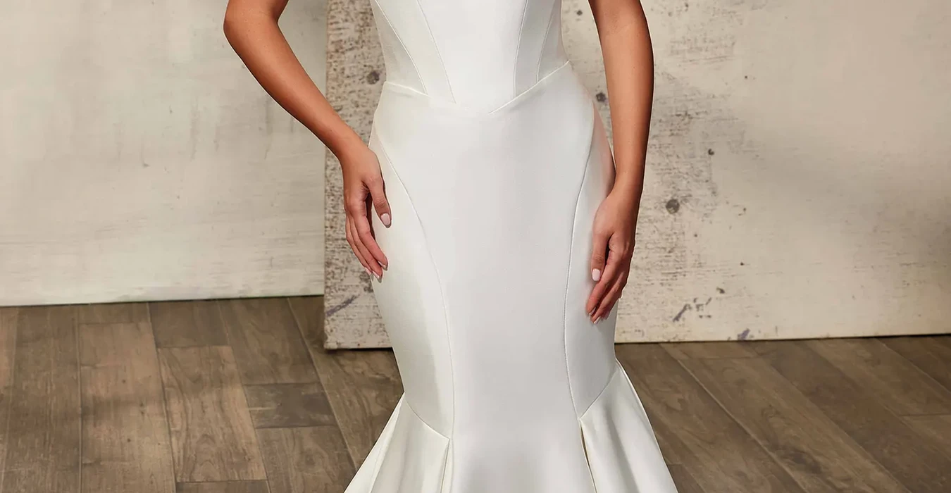 Eddy K strapless mermaid mikado wedding dress with sweetheart neckline photographed on bridal model standing in a studio.