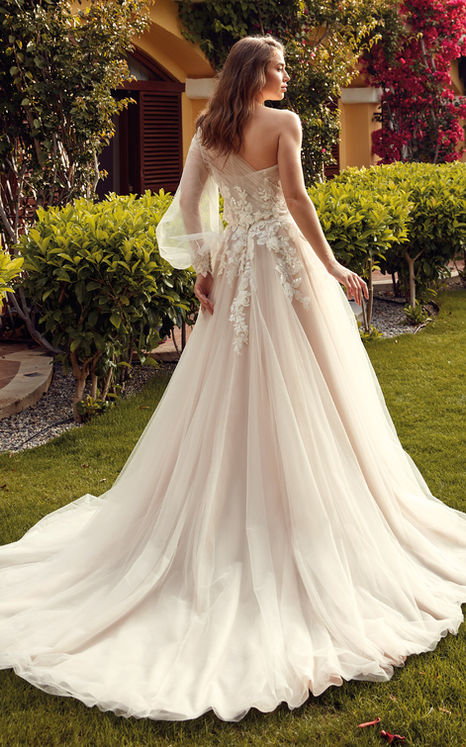 Eddy K champagne ballgown wedding gown with lace details on bride at a garden wedding with jacket